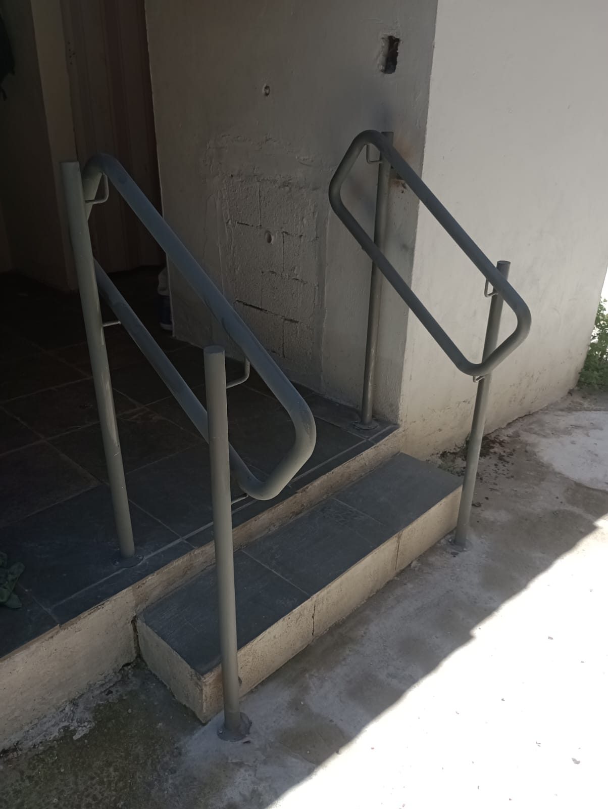 Corrimão duplo de ferro instalado nos degraus de entrada de casa no Grajaú, Zona Sul de São Paulo